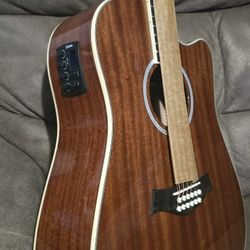 New 12-string acoustic-electric guitar has mahogany finish with cutaway body design. Instrument includes built-in preamp with tuner $220