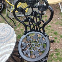 Bistro set two cast iron chairs with metal table