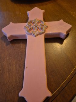 Vintage pink colored wooden cross