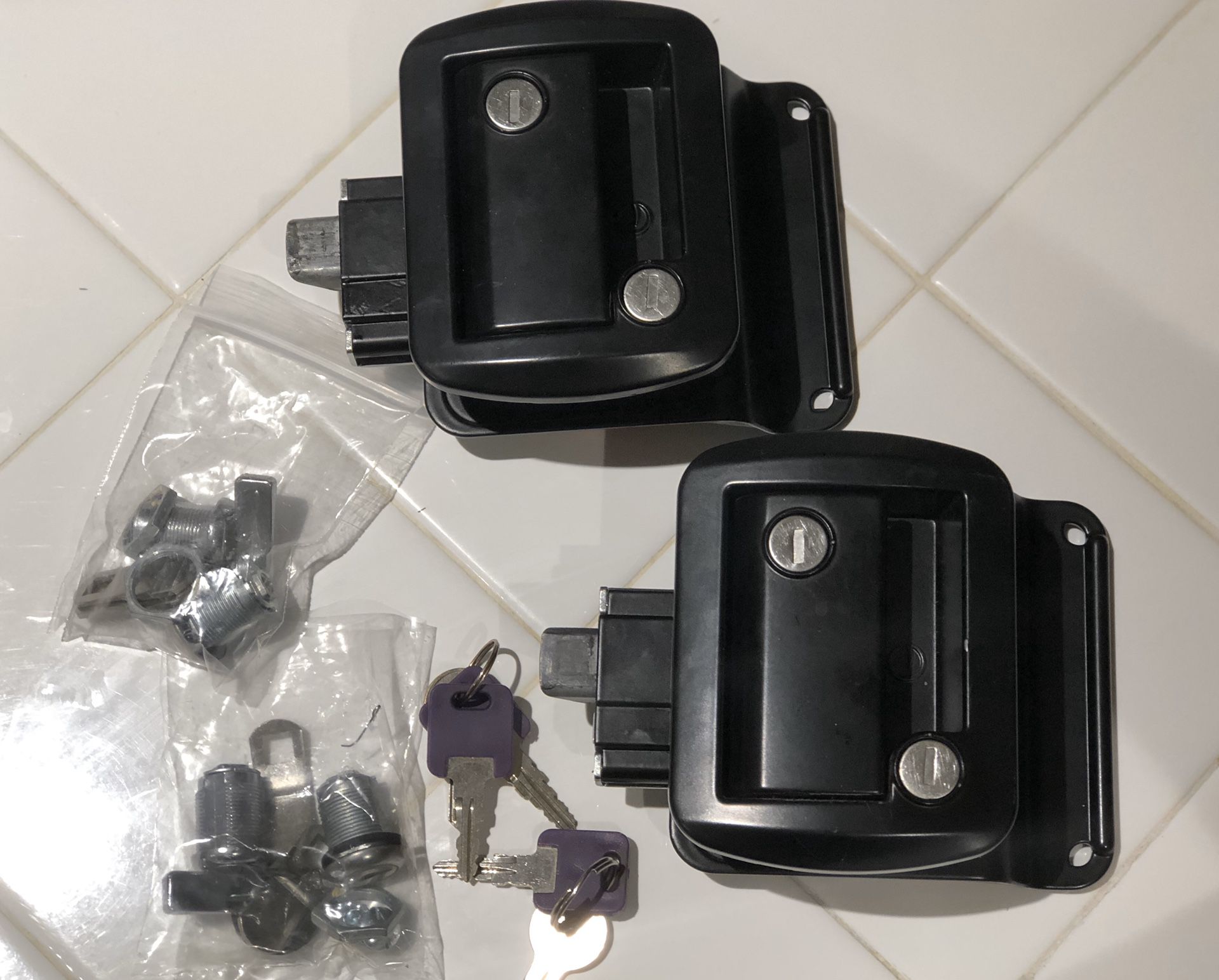 2 Travel trailer locks with keys and 2 storage compartment locks and keys.