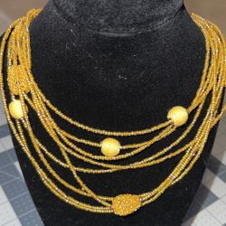 Stamped C1945-Gold tone metal, multi-stranded yellow/gold bead necklace w adj. necklace