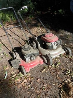 Two nonworking lawnmowers