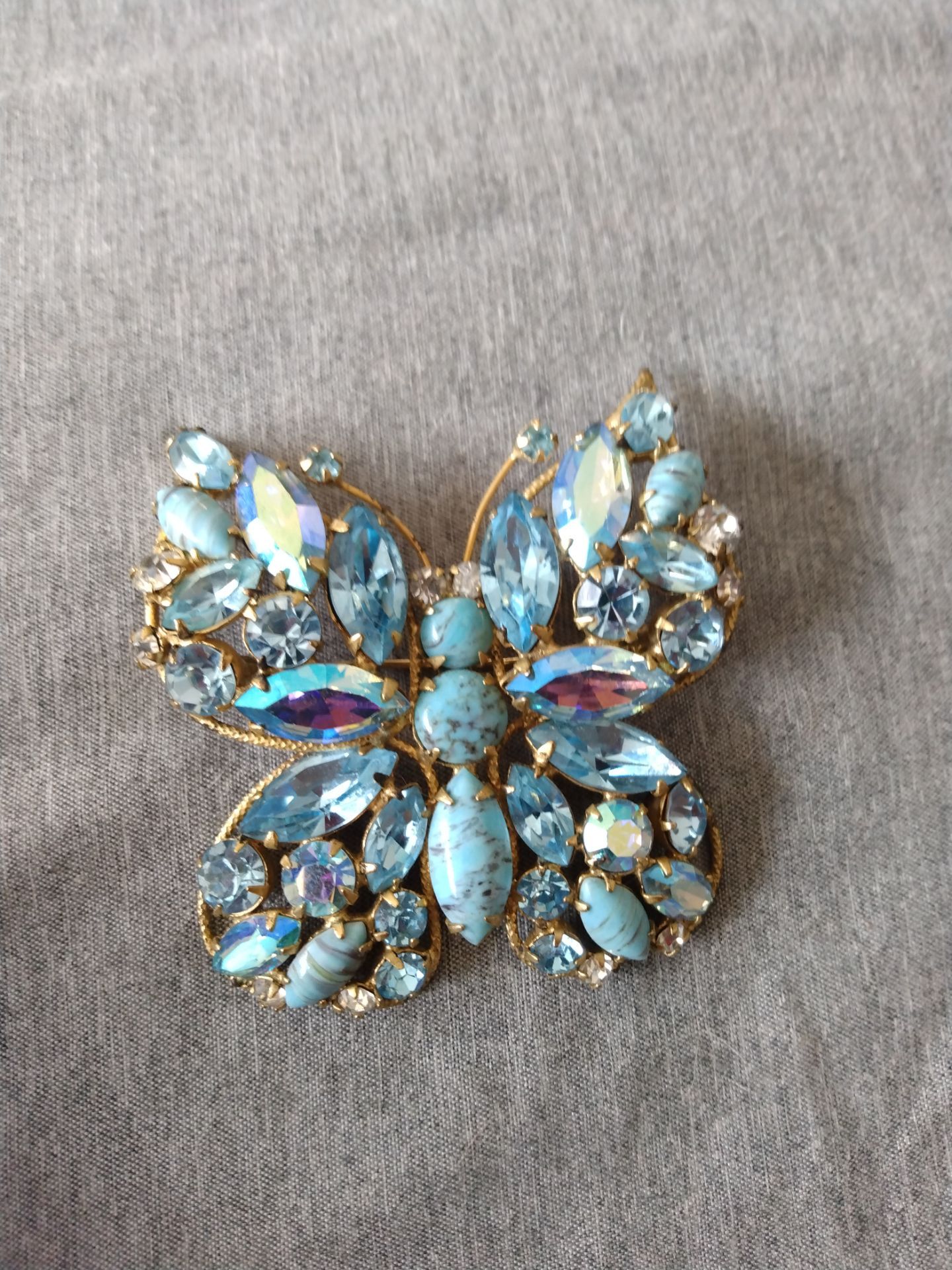Vintage Regency signed brooch with light blue rhinestones and turquoise in gold tone