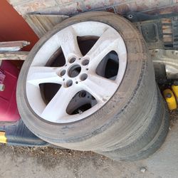 BMW wheels from 2002 325i (3 good 1 has damage from hitting a curb) (tires are old and worn out)