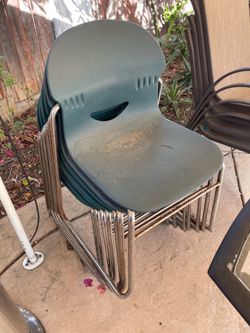 7 Green plastic patio chairs