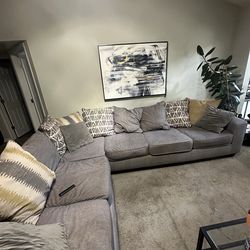 Grey sectional with reversible pillows