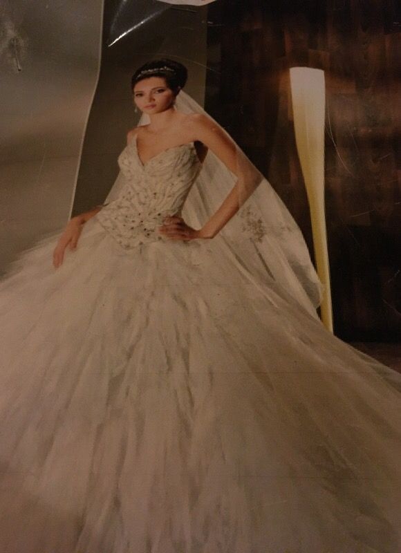 Fully beaded bodice, and dramatic tulle skirt wedding gown