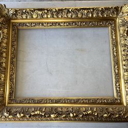 gold ornate Victorian-style picture frame, made of wood