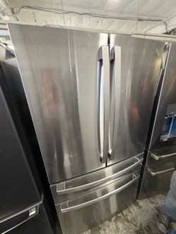 GE fingerprint resistant four-door French Door Refrigerator with dual dispense auto fill pitcher