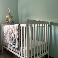 crib with mattress, music hanging toy and blanket