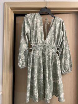 Brand new adorable women’s size medium green and white floral dress with open sides