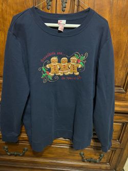 Celebrate the season in this adorable Holiday Editions Christmas sweatshirt featuring three embroidered gingerbread cookies, holly accents, and the sw