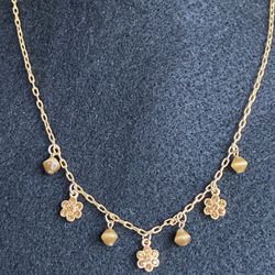 Dainty woman’s gold tone finish necklace with three dazzling rhinestone flowers & four glass beads in earth tone colors.  15” with 3” extender, lobste