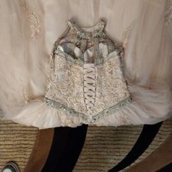 Luxury dress laced in the back. Embroider stones all throughout the dress