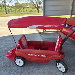 Radio Flyer 2  Seater  Canopy Covered Wagon With Accessory Bag Attached.