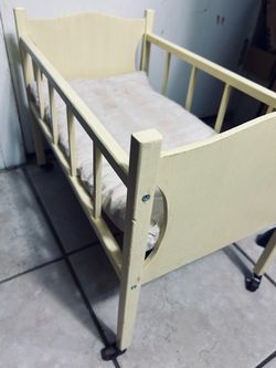 Vintage doll bed on wheels