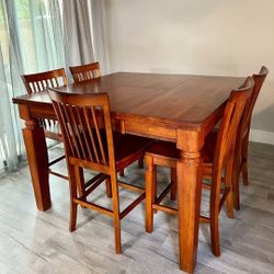 Counter high dining table with 5 chairs and built-in extension leaf 