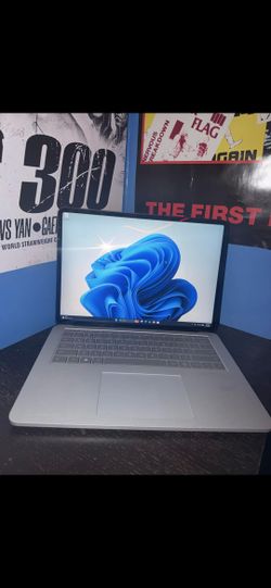 LaptopThis is a Microsoft Surface Laptop Studio in platinum, featuring a unique hinge that allows the screen to pull forward into stage mode.