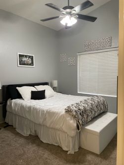 Queen bed with grey headboard two night stands with lamps