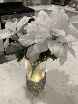 Beautiful vase with flowers and lights