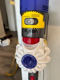Cordless Dyson Vacuum with attachments, filters, and wall mount