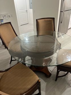 Glass rounded table with four chairs