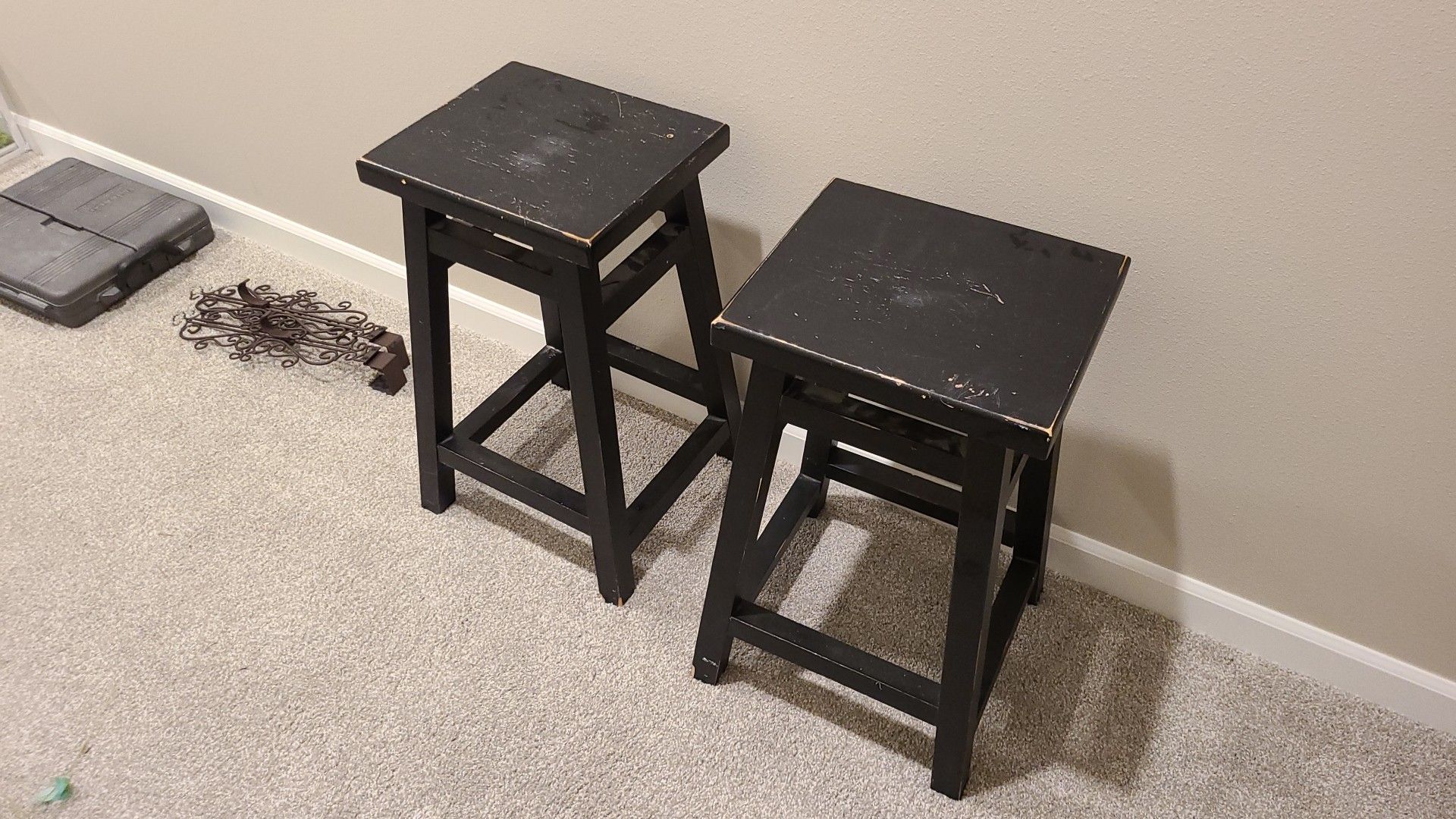 Black distressed bar stools, 24 inches tall.