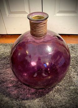 Purple tinted vase with bamboo wrapped stem