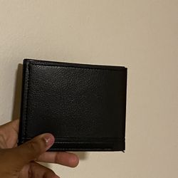 Black leather wallet with card slots and bill compartment