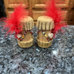 Vintage Buckskin, Beads and red feather Pair of Salt & Pepper Shakers.  Size approximately  2 1/2 inches tall.  Preowned.  Has only been on display in