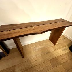 Live-edge console table with brass inlays