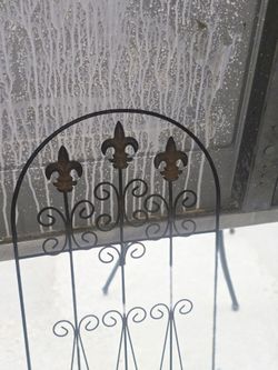 two Victorian style metal fence partials with ground prongs