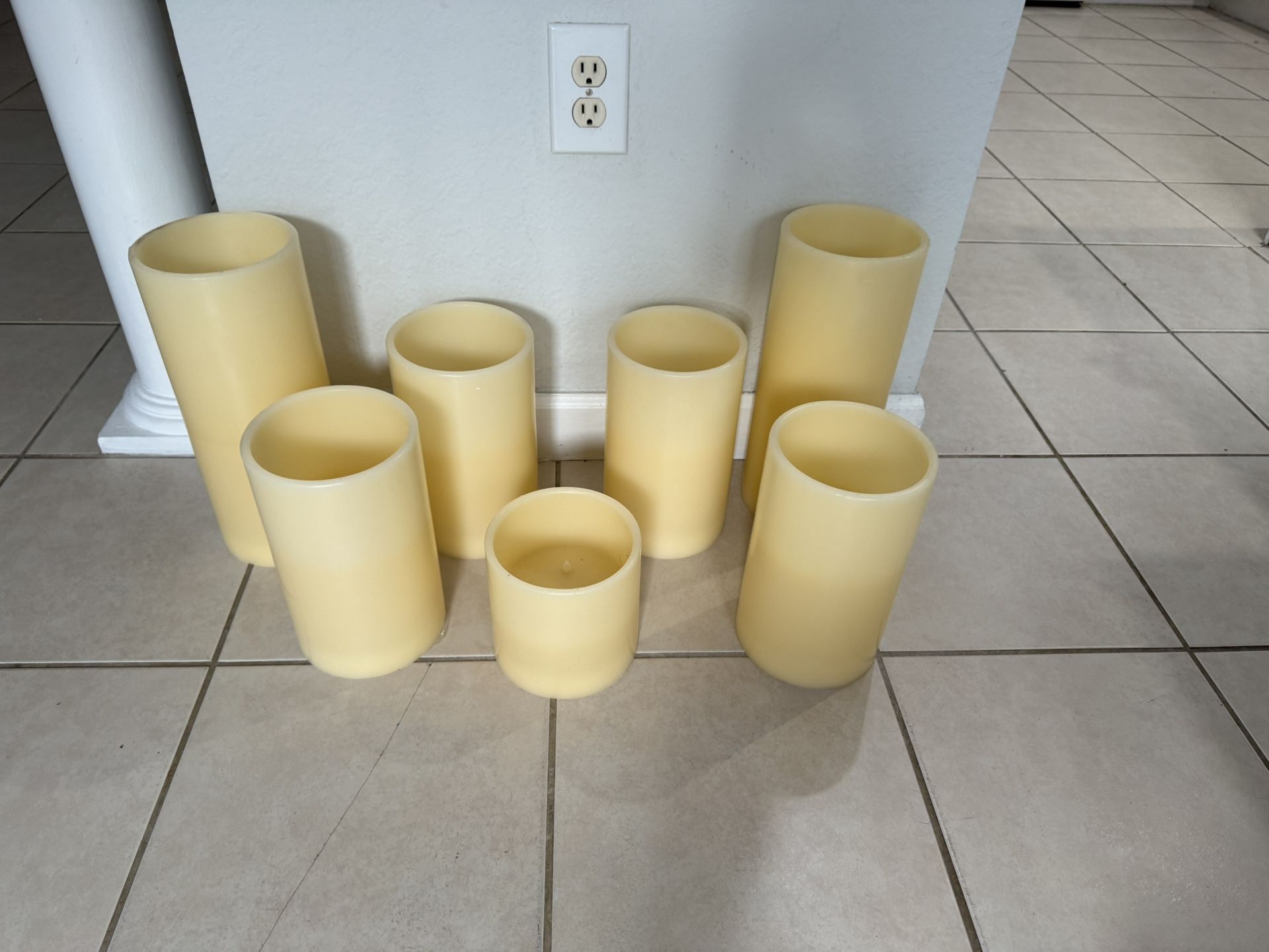 7 Ivory candles light . Battery . Used in good condition. 2 of 14” 4 of 10” and one 6”