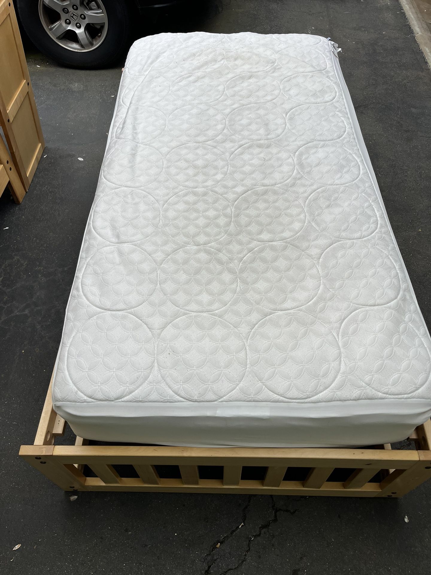 Twin bed with wooden frame