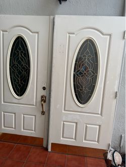 Beautiful double front entry door with decorative oval glass inserts. Removed during a home renovation. Structurally solid and includes both door pane