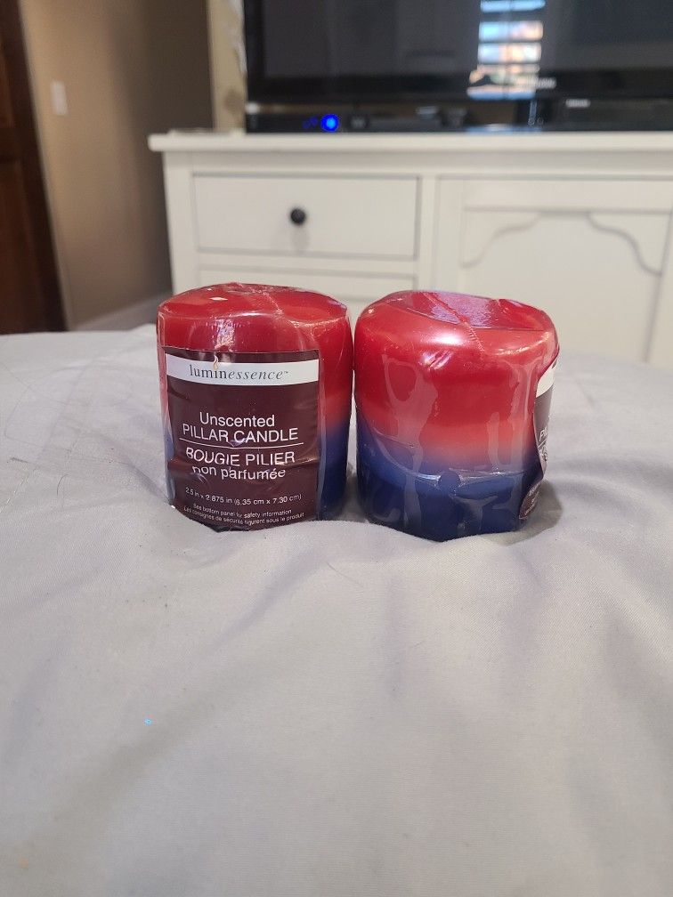 New. (2) Red, White, and Blue Unscented Pillar Candles.