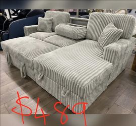 Light gray pullout sofa bed with cup holder console and stirage