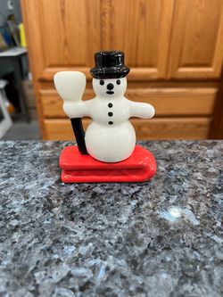 Vintage Ceramic Snowman on a sled pair of salt and pepper shakers. Size approximately 4 inches tall and 3 inches wide. Preowned normal use.