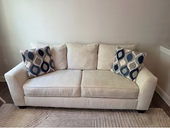 Beige Sofa with Blue Accent Pillows