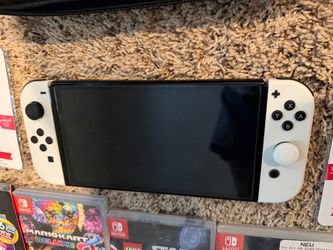 Nintendo Switch OLED Model (White) Console including – Dock, Cables & Travel Case. The games are sold separately.