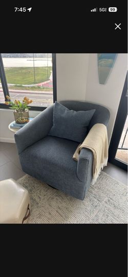 Blue swivel chair with pillow