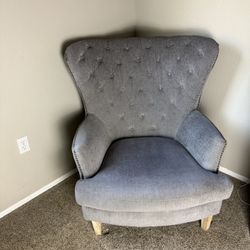 Gray Tufted Wingback chair with nailhead trim