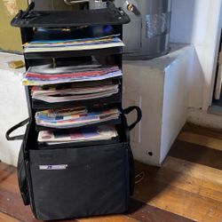 Scrapbooking paper inside a rollaway bag with shelves over 250 pieces of scrap paper also brand new packaged and open Scrap picking materials