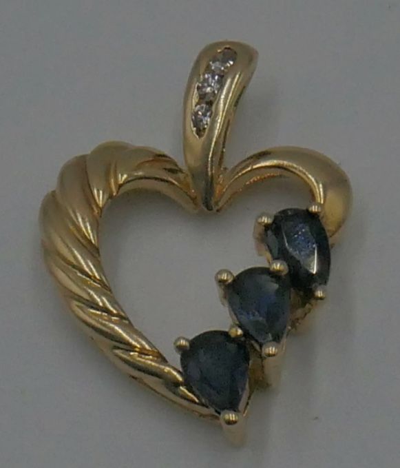 10KT YELLOW GOLD HEART PENDANT W 3 SMALL DIAMONDS; 3 SYNTHETIC SAPPHIRES 2.4 GRAMS. PRE OWNED. MINT CONDITION. 849283-3.