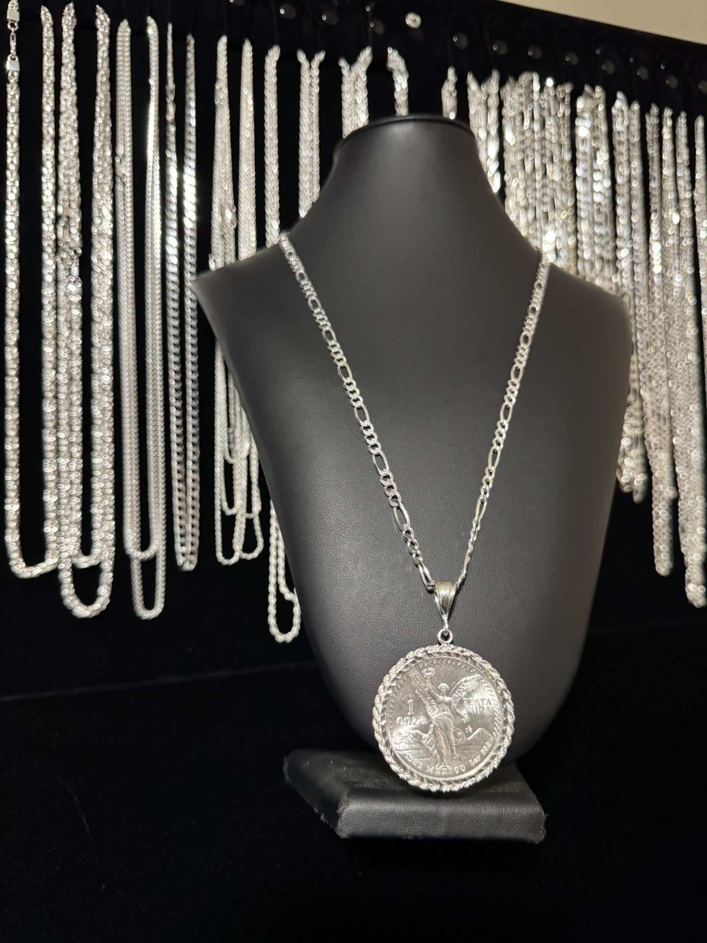 1983 silver centenario with rope bezel and Figaro chain