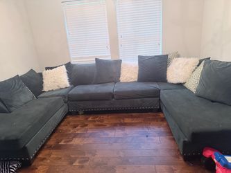 Green sectional with pillows