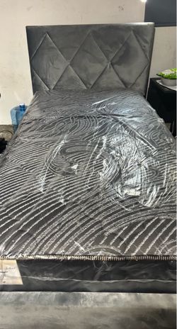 Grey twin bed with headboard