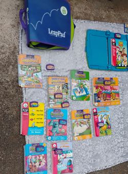 LeapPad Learning System with 2 interactive pads, 13 books with cartridges, binder and Leapster 2 with its OWN 2 additional cartridges