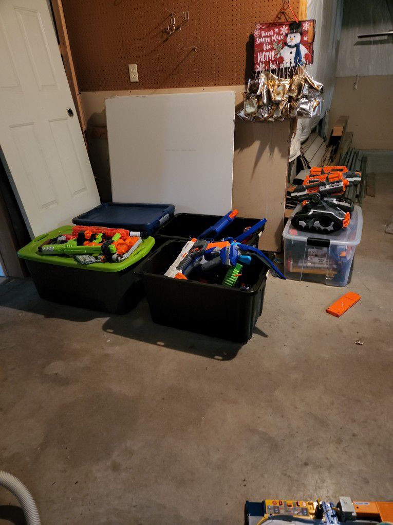 A Bunch Of Nerf Guns And Attachments 