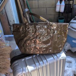 Coach F17729 embossed patent leather shoulder bag featuring silver accents. 